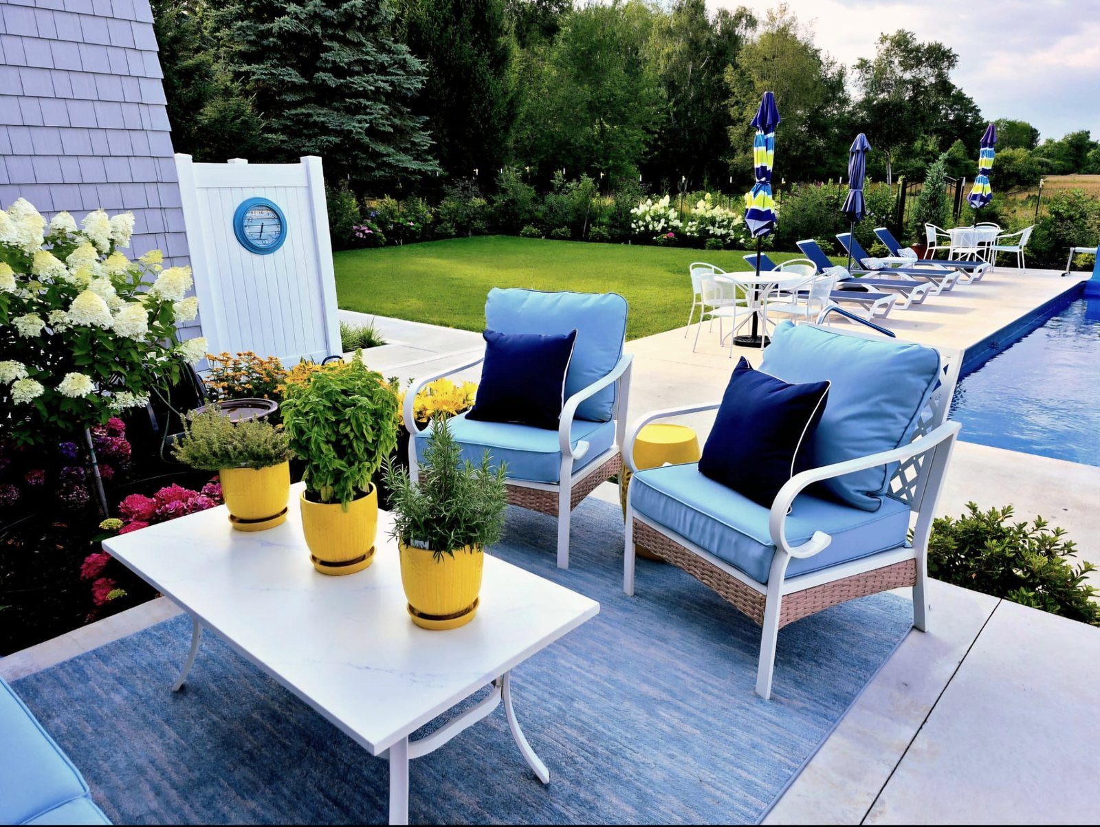 Outdoor patio lounge with cushioned armchairs and coffee table